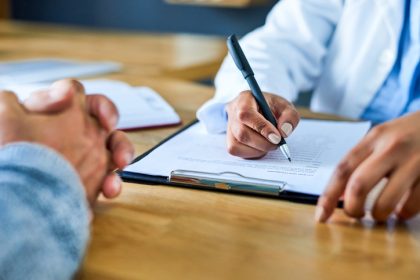 Closeup shot of a doctor writing notes